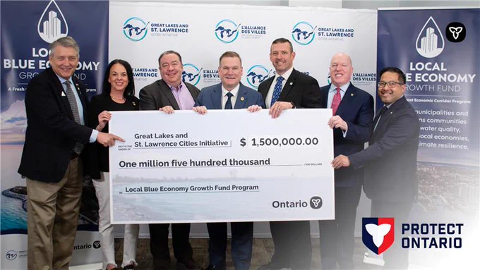 Group of people holding novelty cheque for $1.5 million.