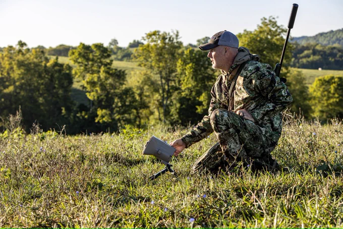 A hunter setting up a coyote stand.