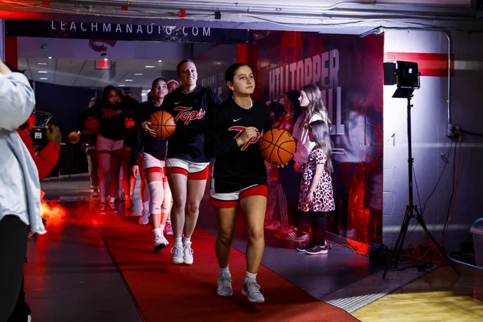 WKU women’s basketball guard Lola Bond leads the team out of the tunnel before a game.