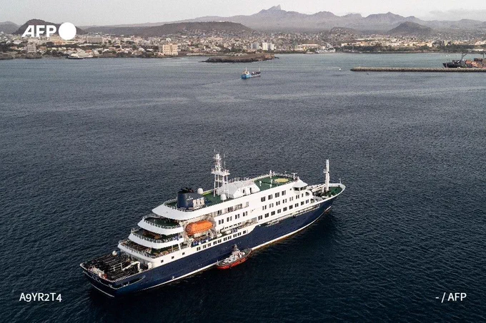Aerial view shows health personnel boarding the cruise ship MV Hondius, while stationary off the port of Praia, the capital of Cape Verde, on May 6, 2026