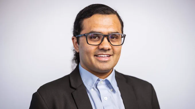 A smiling man in a suit