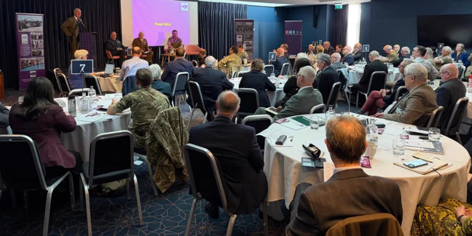 Highland RFCA Chair, Royal Air Force Air Cadets Scotland and Northern Ireland Regional Commandant, Army Regional Command Deputy Commander Cadets, and Colonel Cadets of Headquarters 51 Infantry Brigade and Headquarters Scotland on stage in front of a seated audience.