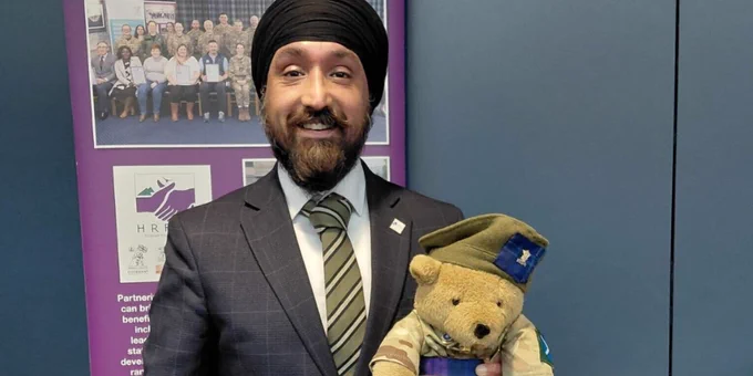 Scottish Chambers of Commerce Chief Executive  holding a teddy bear mascot.