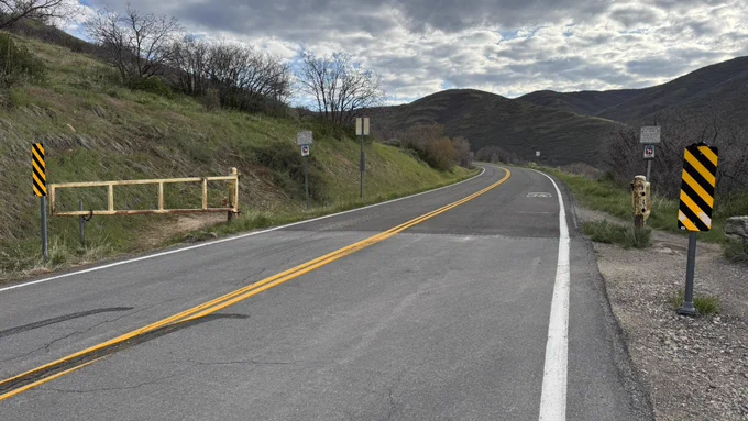 An open gate leading to East Canyon Road.
