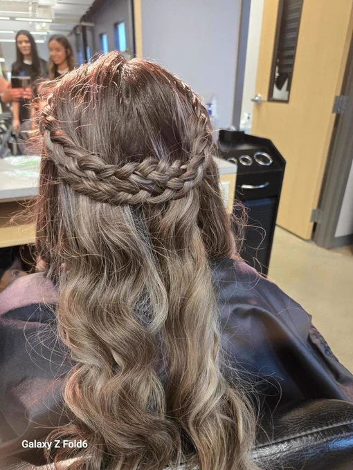 Student photo of braided prom hair with curls styled by cosmetology students at VMHS