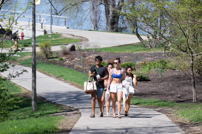 Students walking on a sidewalk.
