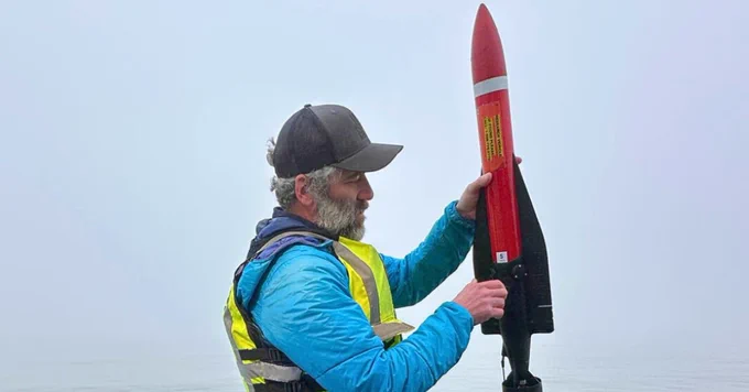 Preparing to deploy an Autonomous Underwater Vehicle (AUV) in the Delaware River for autonomous water-quality data collection. 
