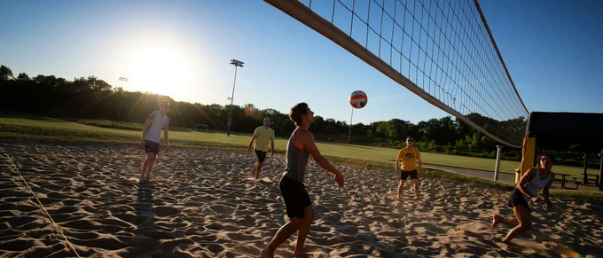 Students playing volleyball. 
