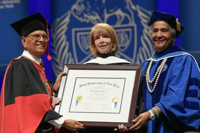 President Tripathi and SUNY Trustee Eunice Lewin present a SUNY Honorary Degree diploma to Mary McLean Wilson. 