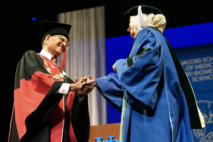 President Tripathi congratulates a graduate at the Jacobs School of Medicine and Biomedical Sciences Commencement ceremony.