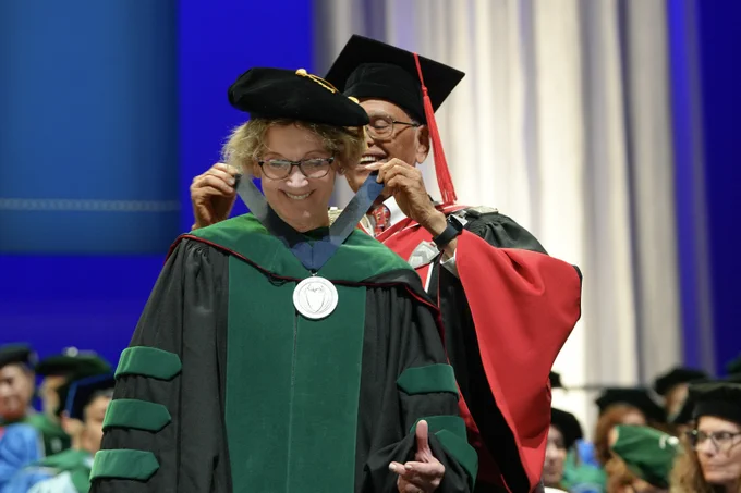 President Tripathi awards a UB President's Medal to Jacobs School dean Allison Brashear.