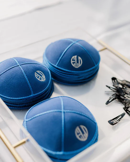 A photo of kippahs with a personalized stitching at a wedding ceremony at Innisbrook Resort in Palm Harbor, FL.