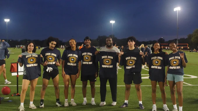 Bug Dawgs players standing with champ shirts, smiling.