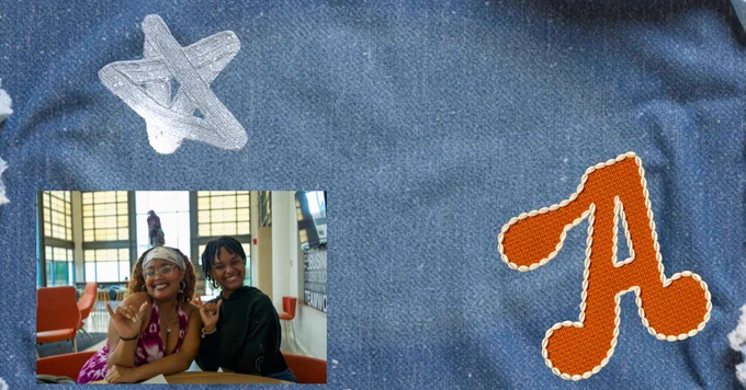 Two people smiling and sitting at a table indoors. The background features large windows. The image is placed on a denim texture with a silver star and an orange letter "A" patch.