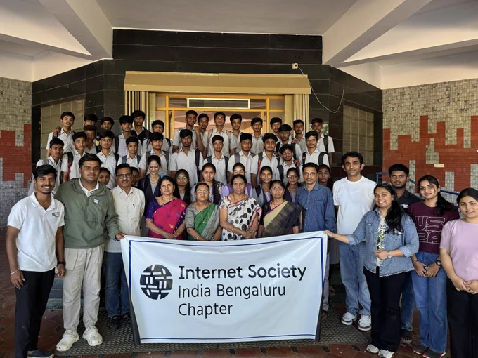 A large group of people stand and hold an Internet Society Bengaluru Chapter banner