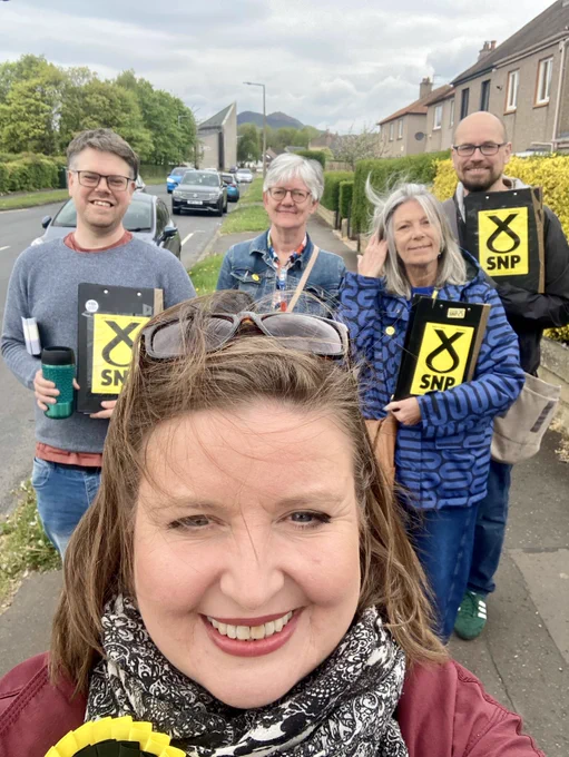 Kate and activists with SNP clip boards smiling at the camera