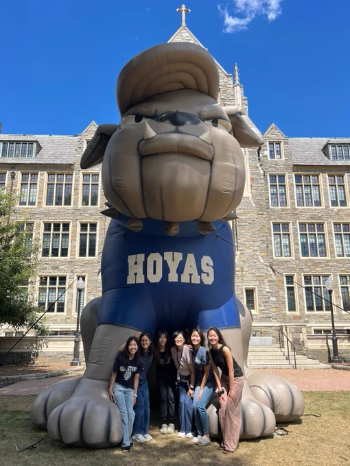 Kim poses with a group of friends in front of an inflatable Jack the Bulldog.
