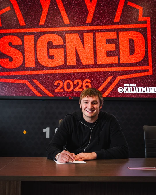 Photo of Athan Kaliakmanis signing his contract.