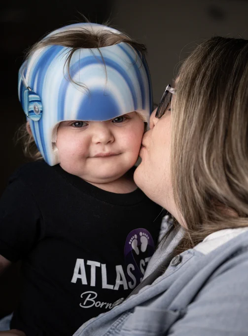 Child in helmet with mother