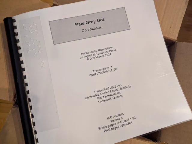 An image of a binder that reads "Pale Grey Dot, by Don Miasek". It's the braille version of Pale Grey Dot, available now from the National Network for Equitable Library Service!