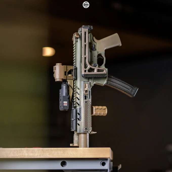 RailScales QTR Stop, RSBM-P Polymer M-LOK VFG, G10 RailScales M-LOK Scales (MiniDot, TerraCore, 3-Slot), G10 Solo's M-LOK Scales (MiniDot, TerraCore, 1-Slot), QDX Sling Mount, Halftop Mount for Scout Light Pro Lights, MCX CSMR Mag Button | Sig Sauer MPX-K SBR, SilencerCo Omega 9K Suppressor, Lancer Systems CF MPX 8" Handguard, Surefire M340V-Pro Scout Light Pro IR Weapon Light w/ SR07-D-IT Switch & Geissele Vampire Light Throw Lever, Aimpoint Micro T-2 RDS in 20150 Cerakote on Unity Tactical FAST Micro Mount, Steiner CQBL-1 Laser on HRF Concepts SKIFF Mount, Geissele MPX Trigger & MPX Charging Handle, Magpul SL FDE Grip, Parker Mountain Machine ULSS Stock.