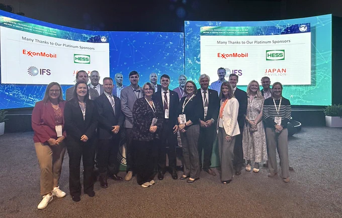 Members from BOEM and BSEE stand together and take a group photo at the Offshore Technology Conference.