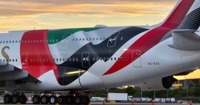 Emirates aircraft with the newly revealed UAE flag artwork as discussions grow around employee bonuses and the airline’s latest branding update