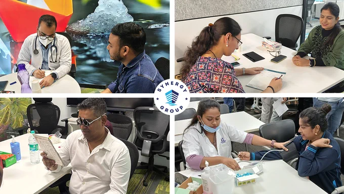 The image shows healthcare professionals conducting medical consultations and routine health screenings for employees during a workplace health check-up initiative at a Synergy office. Colleagues are seen undergoing eye examinations, blood pressure checks and one-on-one medical consultations as part of a preventive healthcare programme organised in partnership with Apollo Hospitals across Synergy offices in India.