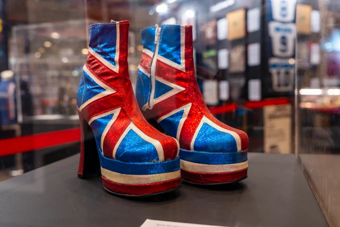 Images from the '1996' exhibition at Barbican Music Library, including Geri Halliwell's platform boots and Liam Gallagher's tambourine. 