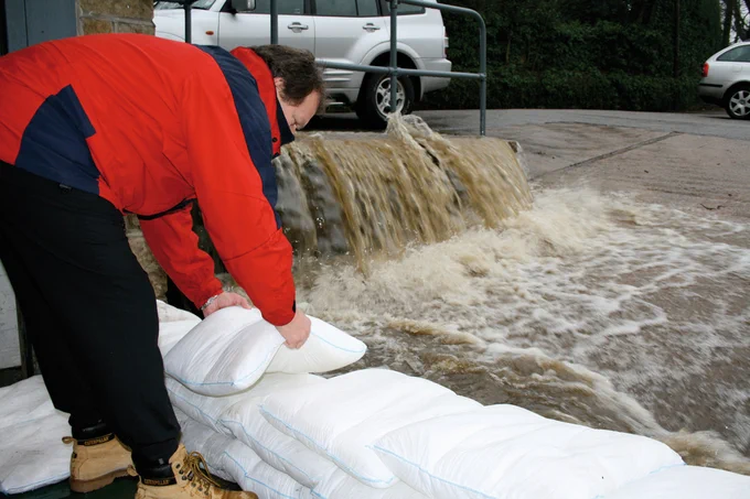 FloodSax alternative sandbags stopping a torrent of floodwater from getting into a warehouse
