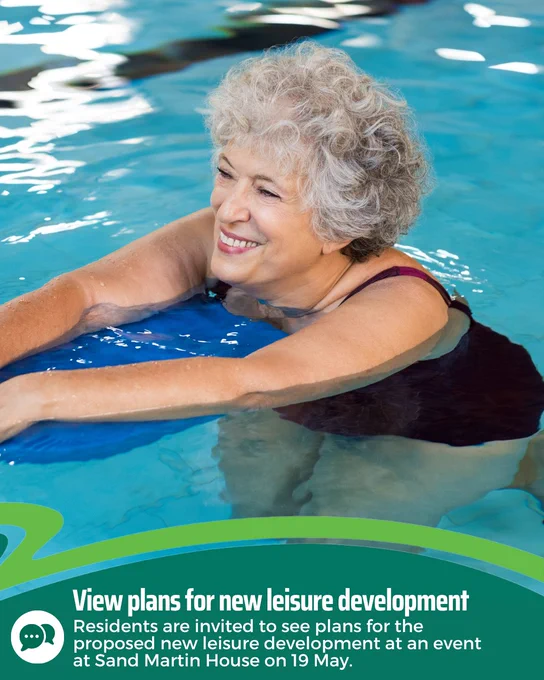 Elderly woman with curly gray hair smiling while floating in a swimming pool, holding onto a blue kickboard. The water is clear and blue. Text at the bottom reads: "View plans for new leisure development. Residents are invited to see plans for the proposed new leisure development at an event at Sand Martin House on 19 May."