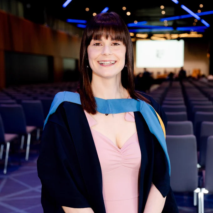 Image of Lyndsey smiling in her graduation robes at the Dublin degree ceremony in Croke Park in March 2026.