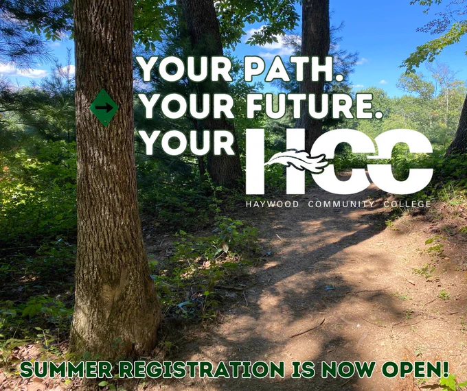 A wooded trail with a green directional arrow on a tree. The text reads, "Your path. Your future. Your HCC" with the Haywood Community College logo. Additional text states, "Summer registration is now open!"