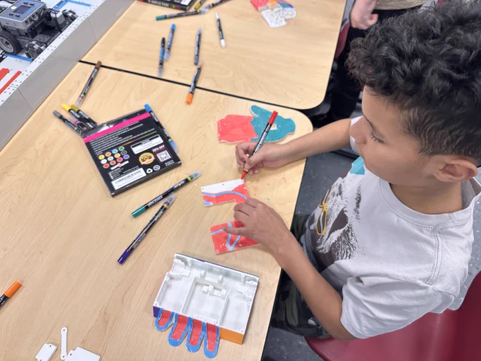 A student designs a colorful BattleBot. 