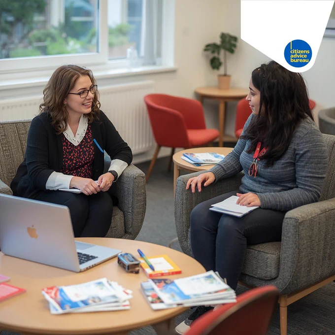 A female adviser providing one to one support and advice to a parent on welfare rights and housing in a school setting.