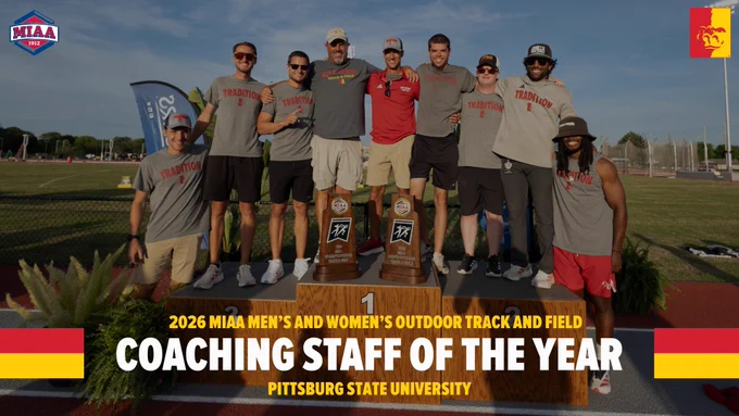Group photo of the Pittsburg State University track and field coaching staff standing on a championship podium at an outdoor track stadium during sunset. Two championship trophies are displayed in front of the group. Most coaches wear gray “Tradition” team shirts, shorts, sunglasses, and hats. Large text at the bottom reads “2026 MIAA Men’s and Women’s Outdoor Track and Field Coaching Staff of the Year – Pittsburg State University.” MIAA logos and red-and-gold school graphics appear in the corners of the image.
