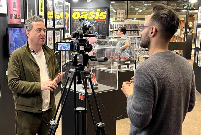 Dominic Mohan being interviewed by the Spanish Agencia EFE News Agency about his '1996' exhibition at Barbican Music Library  