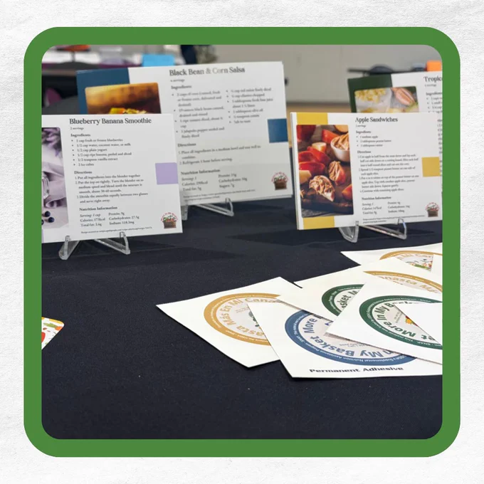Recipe cards on a table with stickers in front, showcasing various foods.