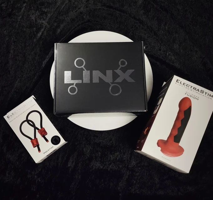 ElectraStim Linx Stimulator and accessories on a black background