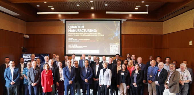 Members of UMD, Purdue, and NAE pose before a screen reading "Quantum Manufacturing"