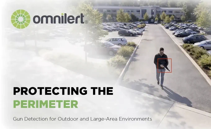 An image of a man walking through a parking lot holding a gun, which has a bounding red AI detection box. On the top left, there is the Omnilert logo. On the bottom left, in bold lettering, it says "Protecting the Perimeter."