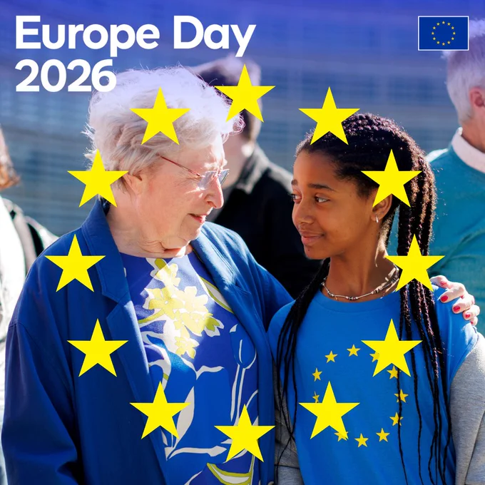 An elderly woman with white hair and glasses and a young girl with long braids look at each other and smile. The woman has her arm around the girl's shoulder. They are framed by a circle of large yellow stars. The text "Europe Day 2026" and a small European Union flag are in the top corners.