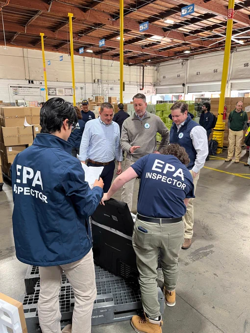 EPA inspectors demonstrating an American Innovation and Manufacturing Act (AIM) Act inspection of a car refrigerator containing an HFC refrigerant to verify that the refrigerant complies with the AIM Act.