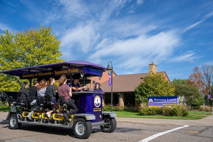 People riding the PedalPoint bike around campus