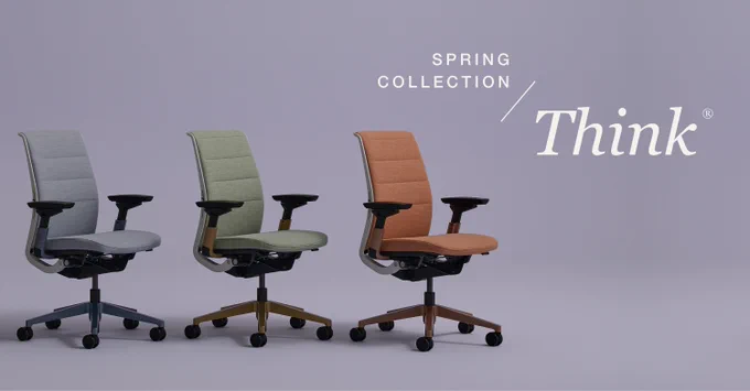 Three Steelcase Think Office Chairs in gray, olive green, and terracotta colors from the Think Spring Collection against a light purple background.
