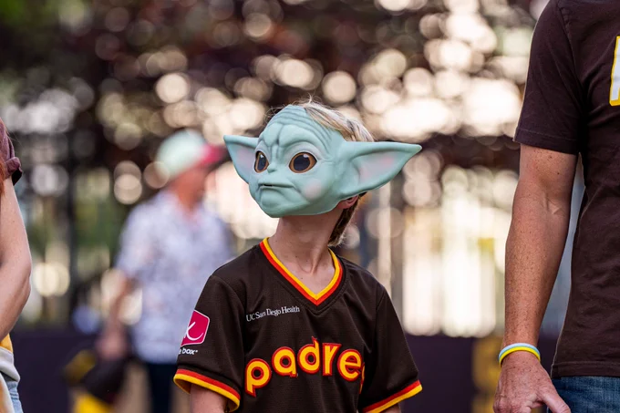 Photo of a Padres fan wearing a Yoda mask.