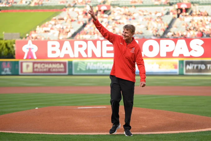 Angels Director of Field/Ground Maintenance Manager Barney Lopas points up and smiles as he walks off the mound, acknowledging his loved ones who watched him toss the ceremonial first pitch in honor of his retirement after 30 years with the Club. 