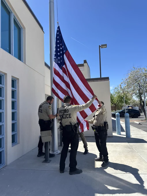 LVMPD officers rep replacing the American flag in front of Southeast area command