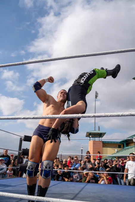 Independent professional wrestler and SoCal Pro Wrestling Heavyweight Champion Mathias flexing and posing with his championship title belt at the Lake Elsinore Storm Baseball Team Stadium; as seen on AEW, WWE Raw, TNA impact and MLW Major League Wrestling.