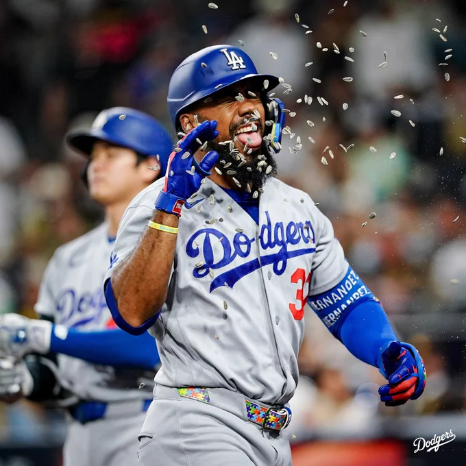 A photo of Teoscar Hernández with sunflower seeds being thrown at his face after hitting a homer.